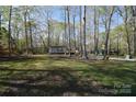 Exterior of home with driveway and mature trees at 121 Silver Fox Ct, Mount Holly, NC 28120