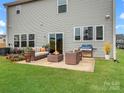 Backyard patio with outdoor seating, grill, and fire pit, perfect for entertaining guests outdoors at 124 Benford Dr, Troutman, NC 28166