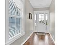 Bright foyer featuring hardwood floors, neutral walls, and a window allowing natural light at 12424 Bradford Park Dr, Davidson, NC 28036