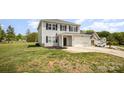 Exterior of a gray home with a large yard on a sunny day at 1436 Yellowstone Ct, Gastonia, NC 28054