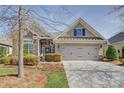 Attractive home with brick and stone accents, a two-car garage, and manicured landscaping at 14916 Creeks Edge Dr, Charlotte, NC 28278