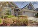 Lovely home with brick and stone features, a two-car garage, and well-maintained landscaping at 14916 Creeks Edge Dr, Charlotte, NC 28278