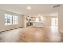 Bright open-concept living area with hardwood floors, connecting seamlessly to the modern kitchen at 1532 Cottage Creek Dr, Bessemer City, NC 28016
