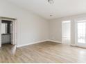 Open-concept living room featuring vinyl wood flooring and patio access at 1671 Sandpiper Dr, Rock Hill, SC 29732