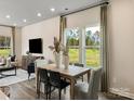 Cozy dining area featuring a wooden table, stylish chairs, and natural light from nearby windows at 1730 Braemar Village Dr, Monroe, NC 28110