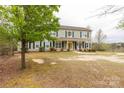 Beautiful two-story home with a covered front porch and lush green surroundings at 1853 Beach Ln, Heath Springs, SC 29058