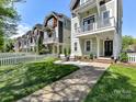 Inviting home exterior showcasing a well-kept lawn, walkway, and charming front porch seating area at 1904 Lela Ave, Charlotte, NC 28208