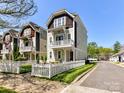 Exterior view of two-story homes, manicured lawn, white picket fence and street at 1904 Lela Ave, Charlotte, NC 28208