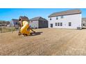 Large backyard featuring a playhouse with a slide, offering ample space for recreation and relaxation at 2031 Killian Creek Dr, Denver, NC 28037