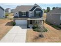 Beautiful two-story home with a well-maintained lawn, a two-car garage, and attractive architectural details at 2031 Killian Creek Dr, Denver, NC 28037
