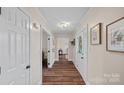 Inviting hallway featuring hardwood floors, neutral walls, and contemporary lighting fixtures at 235 Stafford Estates Dr, Salisbury, NC 28146