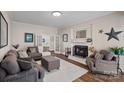 Cozy living room with a fireplace, comfortable seating, and ample natural light from french doors at 235 Stafford Estates Dr, Salisbury, NC 28146