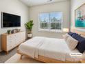 Cozy staged bedroom with a soft rug, natural light, and modern furnishings at 2557 Grantham Place Dr, Fort Mill, SC 29715