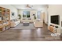 Bright, staged living room featuring hardwood floors, stylish furniture, and natural light at 2557 Grantham Place Dr, Fort Mill, SC 29715