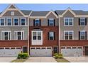 Charming townhome with brick facade, gray siding, and a one-car garage offers comfortable living at 2619 Grantham Place Dr, Fort Mill, SC 29715