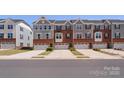 Attractive brick and gray sided townhomes with one-car garages and well-maintained landscaping at 2619 Grantham Place Dr, Fort Mill, SC 29715