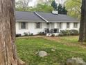 Charming white brick home with a well-manicured lawn and mature trees at 2701 Rea Rd, Charlotte, NC 28226