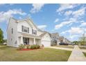 A neighborhood street view with similar two-story homes boasting well-kept lawns and sidewalks on a sunny day at 2893 Yeager Nw Dr, Concord, NC 28027