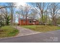Traditional red brick home with driveway and mature trees offering shade and curb appeal at 304 Simrill Ave, York, SC 29745