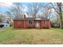 Well-maintained red brick home with a tidy front yard, complemented by blooming azaleas at 304 Simrill Ave, York, SC 29745