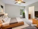 Bright bedroom with a ceiling fan, carpeted floor, and an ensuite bathroom at 3155 Golden Dale Ln, Charlotte, NC 28262