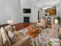 Bright living room featuring a fireplace, hardwood floors, and comfortable seating at 3155 Golden Dale Ln, Charlotte, NC 28262