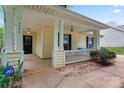 Inviting covered front porch with classic columns and cozy seating area at 4020 Brandie Glen Rd, Charlotte, NC 28269