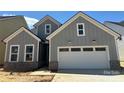 Charming new construction home with gray siding, white trim, and a two-car garage at 4126 Eastover Glen Rd # 0317, Charlotte, NC 28269