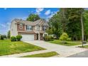 Spacious two-story home with a large front yard, two-car garage, and a well-maintained lawn at 4924 Riverdale Dr, Charlotte, NC 28273