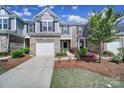 Inviting townhome with a one-car garage and beautiful landscaping, enhancing curb appeal at 526 Hunters Dance Rd, Fort Mill, SC 29708