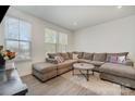 Inviting living room featuring a large sectional sofa, neutral tones, and natural light from the windows at 532 Billingsley Rd, Charlotte, NC 28211