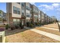 Exterior street view of modern townhomes showcasing brick and siding design with sidewalk and landscaping at 532 Billingsley Rd, Charlotte, NC 28211