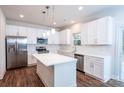 Bright kitchen featuring an island, stainless steel appliances, and white cabinetry at 618 Sharon Dr, Statesville, NC 28625