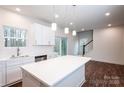 Kitchen boasts white cabinets, island with countertop, and stainless steel dishwasher at 618 Sharon Dr, Statesville, NC 28625
