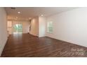 Open-concept living room features hardwood floors and access to kitchen and backyard at 618 Sharon Dr, Statesville, NC 28625