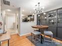Inviting dining area featuring modern lighting, wood floors, and an open layout at 753 Mountainwater Dr, Charlotte, NC 28262