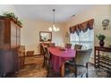 Charming dining room with hardwood floors, elegant chandelier and lovely decor at 10421 Dominion Village Dr, Charlotte, NC 28269