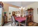 Dining room featuring hardwood floors, and a charming chandelier at 10421 Dominion Village Dr, Charlotte, NC 28269