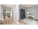 Inviting hallway with archways, stylish flooring, and a view into the living room and an office space at 10694 Sapphire Trl, Davidson, NC 28036