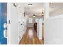 Bright entryway features gleaming hardwood floors and an open view into the adjacent living spaces at 107 Forester St, Mooresville, NC 28117