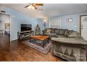 Inviting living room with a comfortable gray couch, wood floors, and soft blue walls at 113 Hidden Ln, Mooresville, NC 28117