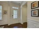 Welcoming entryway featuring hardwood floors, decorative glass door, and neutral paint creating a warm and inviting atmosphere at 16524 Palisades Commons Dr, Charlotte, NC 28278