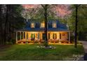 Charming home with a welcoming porch and three dormer windows nestled among trees, radiating a cozy and inviting ambiance at 2095 Westridge Dr, Rock Hill, SC 29732