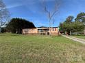 A single story home on a sprawling lawn with mature trees and a blue sky backdrop at 236 Bowmans Cutover Rd, Taylorsville, NC 28681