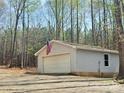 Detached garage with American flag accent, siding, and single window in a tree-filled lot at 245 Clontz Hill Rd, Troutman, NC 28166