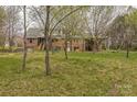 View of the back of the house with trees surrounding the yard at 2705 Robinson Rd, Newton, NC 28658