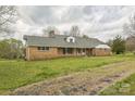 Brick ranch-style home featuring a large yard and a covered front porch, seen from a side angle at 2705 Robinson Rd, Newton, NC 28658