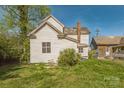 Back view of a two-story white home with an overhanging roof at 303 E Fisher St, Salisbury, NC 28144