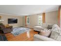 Bright living room featuring hardwood floors, large windows, and comfortable seating area at 317 S Lineberry St, Troy, NC 27371
