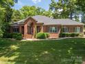 Beautiful brick home with mature trees and lush green lawn at 3964 Deer Run Ne Dr, Conover, NC 28613
